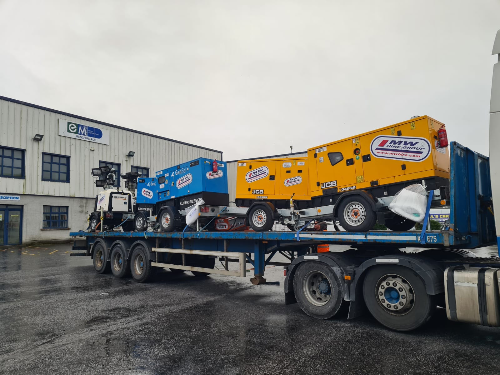 Load of generators and lighting towers heading to a rental project